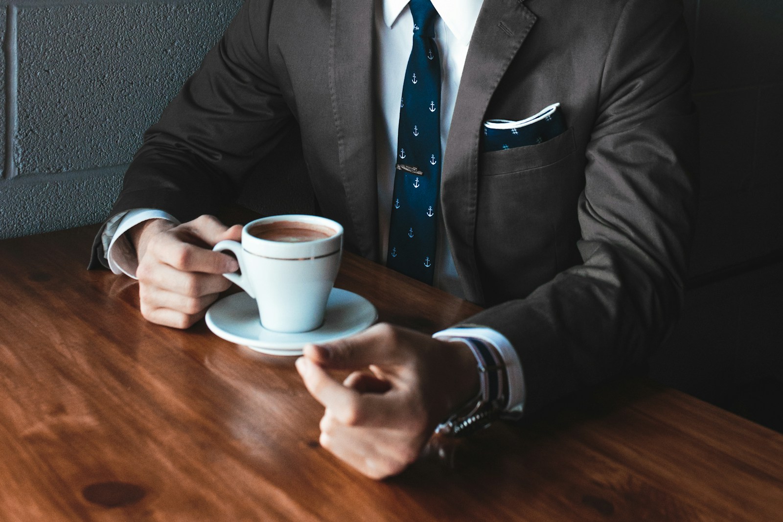 man holding cup filled with coffee on table discussing personal lines insurance